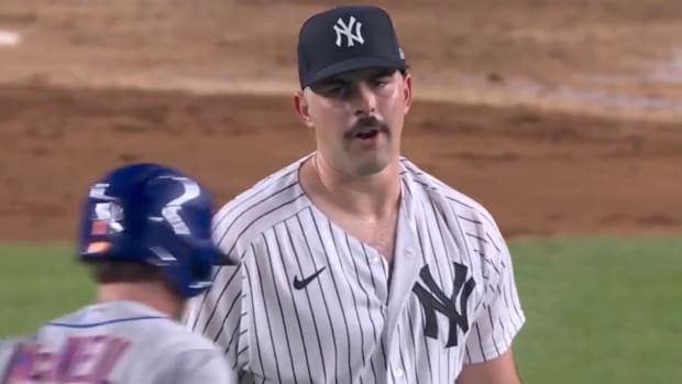 Carlos Rodon talks with Jeff McNeil
